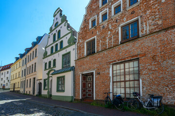 Fototapeta na wymiar Historical house facades against the blue sky in the old town of Wismar on the Baltic Sea, Germany