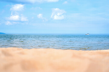 Close up of sand shore with blurred sea background.