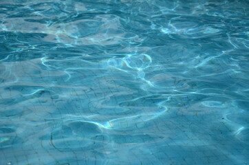 Clear and transparent water in the pool, water texture background.