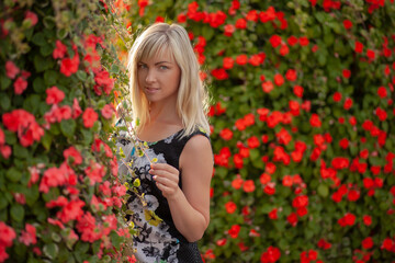 Naklejka premium Young blond girl in dark dress