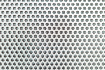 Close up round patterned on metal wall for background.