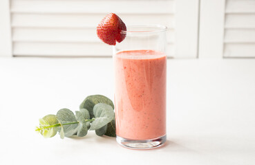 strawberry smoothie in a glass beaker isolated on a white background
