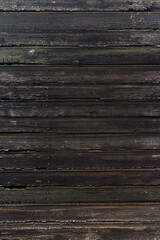 background of the burned wall surface of wooden planks