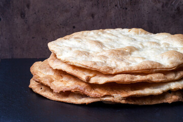 Appetizing puff pastry cakes. Golden cakes for Millefeuille or Napoleon cake on a black background.