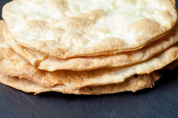 Appetizing puff pastry cakes. Golden cakes for Millefeuille or Napoleon cake on a black background.
