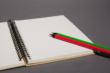 spiral notebook with colored pencils, view from above