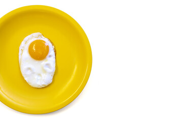 One fried egg with raw yolk on bright yellow plate, isolated on white background. Diet portion concept, food, meal, breakfast. Copy space. Best protein source. Top view.