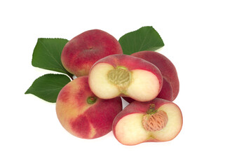 Fig peaches and their halves with leaves isolated on white