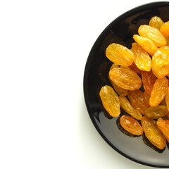 Large light raisins in a black plate.