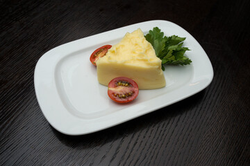 mashed potato with tomato on white plate
