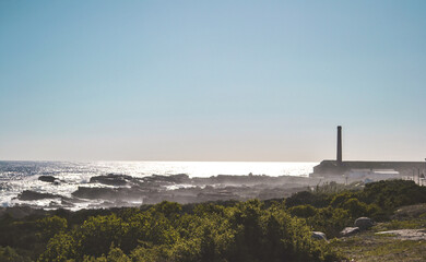 Fototapeta premium Lighthouse agains a misty ocean background