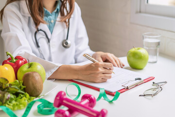 Nutritionist giving consultation to patient with healthy fruit and vegetable, Right nutrition and...