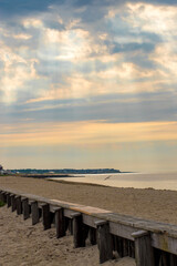 Sun rays breaking through clouds over West Dennis Beach, Yarmouth, Cape Cod on an early summer...