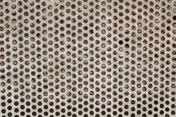 Background for an industrial theme. The surface texture of the metal grill with round holes.
