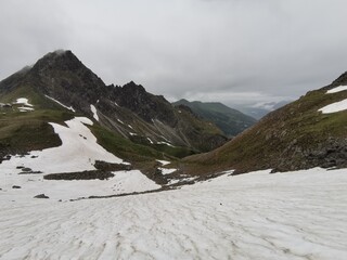 snow fields on a hiking path in the alps in spring