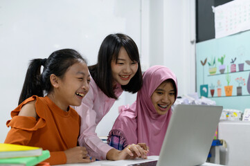Primary school children in class with the teacher on the first day of school.