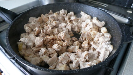 meat pork is fried in a frying pan