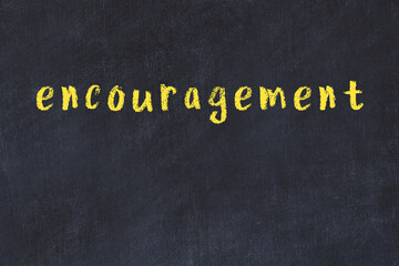 Black chalkboard with inscription encouragement on in