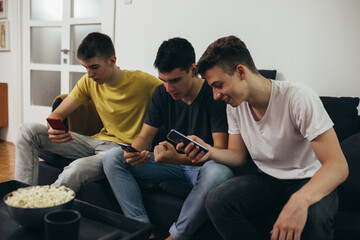 teenager boy using mobile phone at home