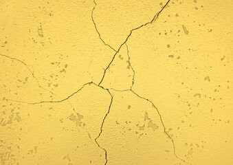 Grunge yellow concrete wall with crack