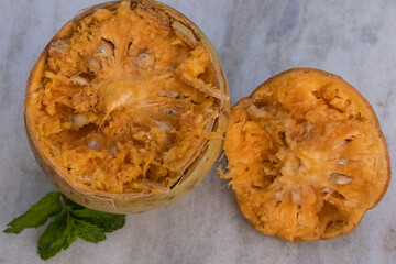 Image of bael fruit and a glass of bael juice