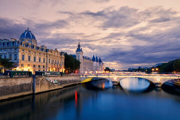 View on the Conciergerie and the seine river banks at sunset in Paris, France