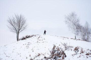 human on hill watching somewhere 