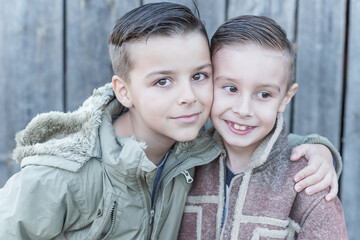 boy's two brothers stand embracing