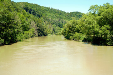 Iller river in bavaria after rain with muddy water in a nature park