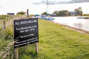  Public boat moorings on Thurne Dyke off the River Thurne in the Norfolk Broads National Park on a summers evening