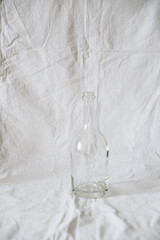 Transparent glassware on a light fabric background