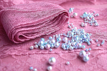 A skein of pink purple guipure lace along with lilac 
blue pearls beads for embroidering jewelry...