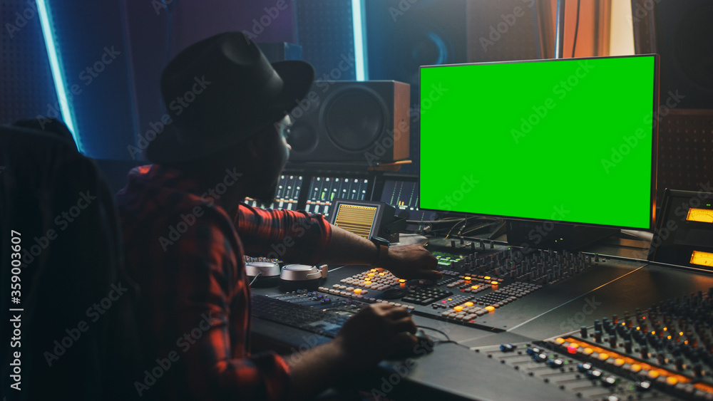 Aufkleber portrait of stylish audio engineer / producer working in music record studio, uses green screen comp