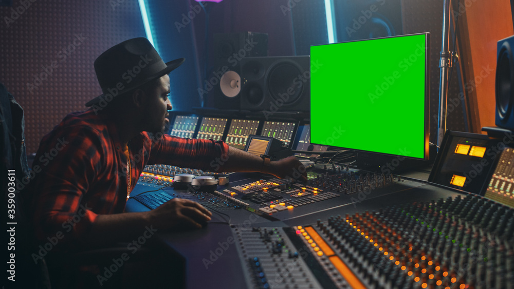 Aufkleber stylish audio engineer / producer working in music record studio, uses green screen chroma key compu
