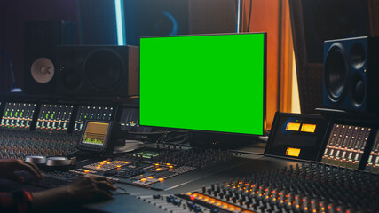 Portrait of Stylish Audio Engineer Working in Music Record Studio, Uses Green Screen Computer,...