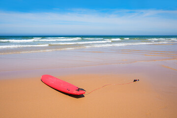 lonely surfboard at the sandy beach, atlantic ocean Portugal