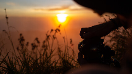 A photographer photographs the dawn of the sun on the volcano Batur. Bali Indonesia