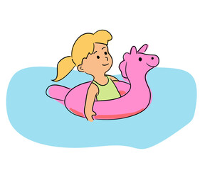 Little cute girl swimming with rubber unicorn ring in pool water
