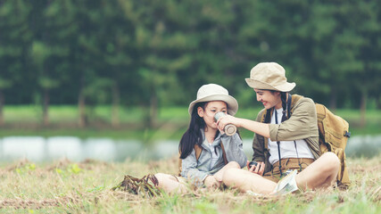 Group student asian young women and girl traveler with backpack adventure drinking water for relax. Family people holding map to find directions 