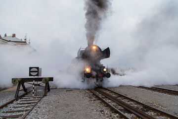 Fototapeta na wymiar Old steam train - locomotive leaves the Nova Gorica railway station