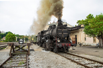 Fototapeta na wymiar Old steam train at the train station of Most na Soci, Slovenia