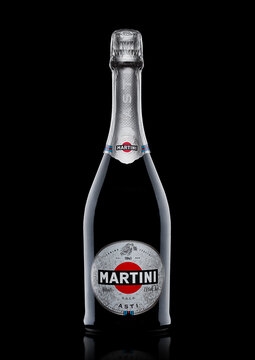 LONDON, UK - November 24, 2017: Bottle and glass of sparkling wine Martini Asti on black. Produced in Italy