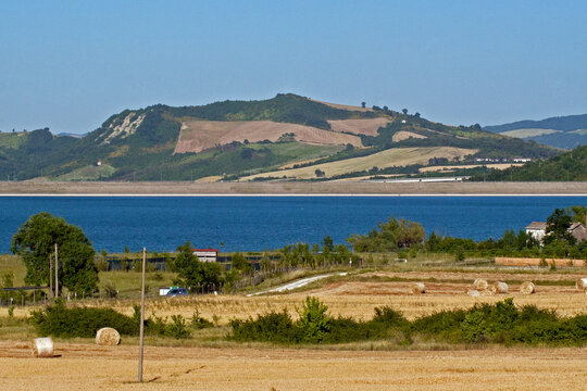 landscape with the lake of Conza della Campania and cultivated fields on the hill. Campania, Irpinia, Avellino, Italy.