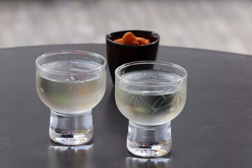 2 cups of sake with Japanese crackers