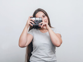 Girl photographer takes a photo with an old film camera