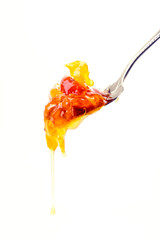 dripping orange jam from a spoon