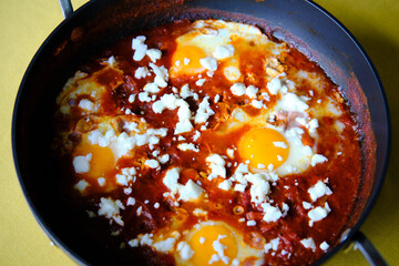Shakshuka in a Frying Pan. Eggs Poached in Spicy Tomato Pepper Sauce.