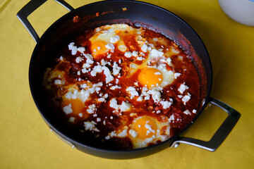 Shakshuka in a Frying Pan. Eggs Poached in Spicy Tomato Pepper Sauce.