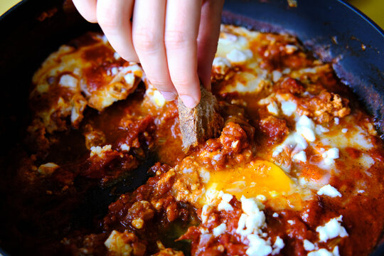 Shakshuka in a Frying Pan. Eggs Poached in Spicy Tomato Pepper Sauce.