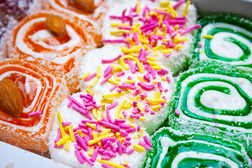 Turkish delight with multi-colored sprinkles, almonds and coconut close-up